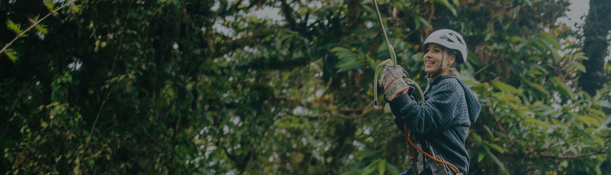 girl enjoying while going through the forest in a canopy 